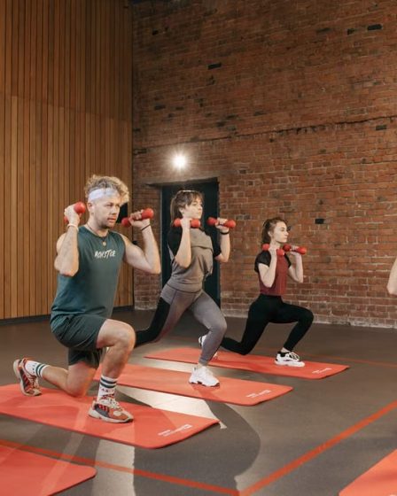 Indoor group workout session with dumbbells focusing on strength and fitness.